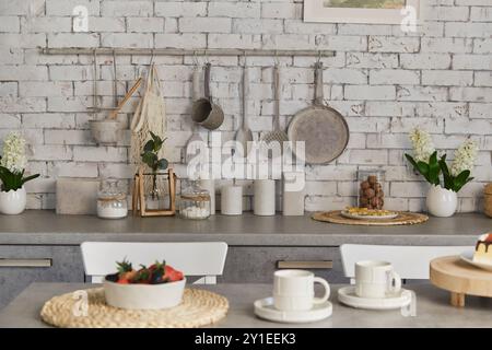 Contemporary kitchen scene featuring fruits and berries and coffee for two. Selective focus. Stock Photo
