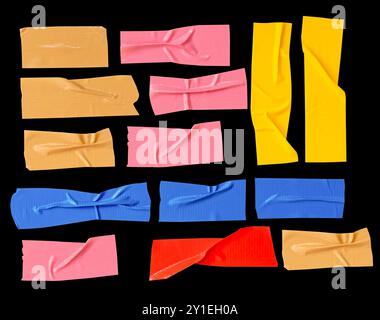 Top view set of multicolor adhesive vinyl tape or cloth tape in stripes is isolated on black background with clipping path. Stock Photo