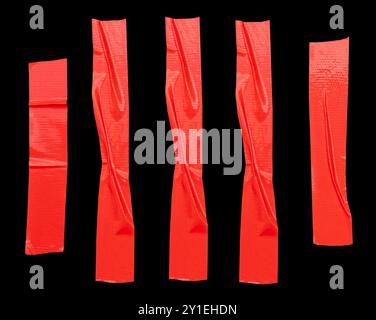 Top view set of red adhesive vinyl tape or cloth tape in stripes is isolated on black background with clipping path. Stock Photo