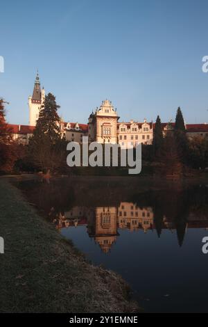 Prague, Czech republic - October 29, 2021: Renaissance pruhonice castle reflecting on calm lake surface at sunset autumn in Pruhonice park Stock Photo