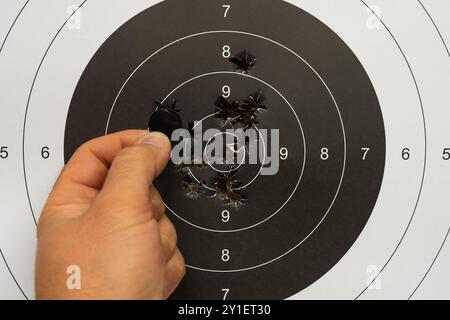 Man Weapon bullseye target training in a shooting club Stock Photo - Alamy