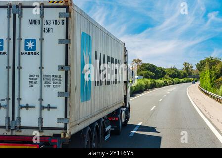 Cadiz, Andalusia, 2/21/2024; Truck driving on a highway with a maritime container from the Maersk company. Stock Photo