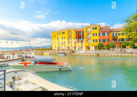 A small boat harbor at the colorful, medieval resort town of Sirmione, Italy, on the shores of Lake Garda in Northern Italy Stock Photo