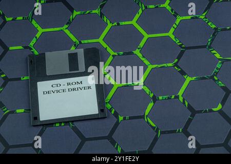 Colorful old floppy disks for old 16-bit and 8-bit 3.5-inch computers arranged on a black keyboard and mouse pad Stock Photo