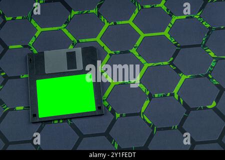 Colorful old floppy disks for old 16-bit and 8-bit 3.5-inch computers arranged on a black keyboard and mouse pad Stock Photo