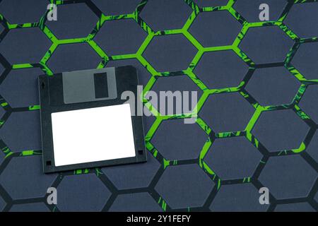 Colorful old floppy disks for old 16-bit and 8-bit 3.5-inch computers arranged on a black keyboard and mouse pad Stock Photo