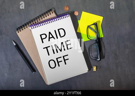 Paid Time Off is shown on a photo using the text. Stock Photo