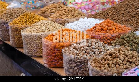Traditional Moroccan snacks, nuts, candies and sweets at Souk el Had market in Agadir, Morocco. Assortment in oriental market Stock Photo