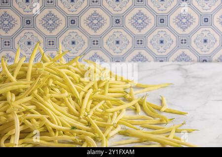 A pile of yellow beans on a marble worktop Stock Photo