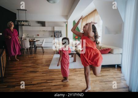 Happy family enjoying playful dance in modern living room Stock Photo