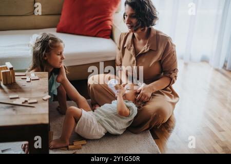 Mother and daughters spending quality time together at home Stock Photo