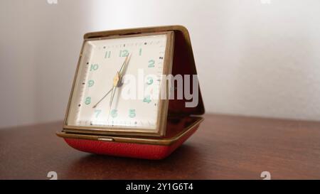 Antique vintage clock on wooden table Stock Photo