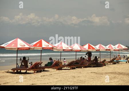 Sunshades for visitors on Kuta Beach, Badung, Bali, Indonesia. Stock Photo