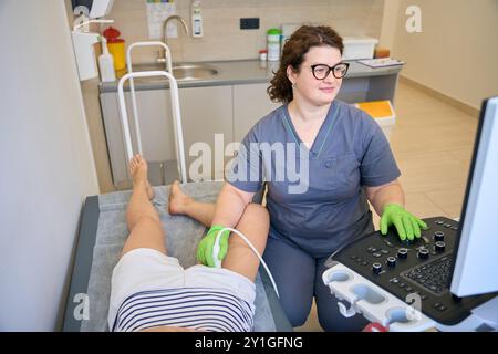 Patient in comfortable clothes lies on medical couch Stock Photo