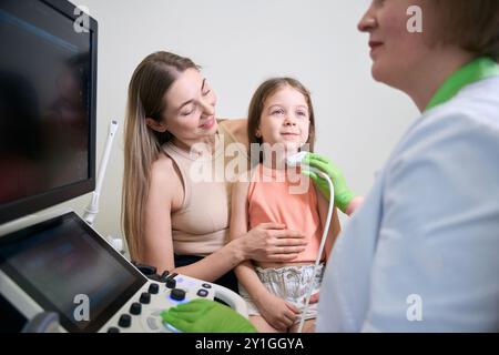 Doctor holding ultrasound probe during a medical examination Stock Photo