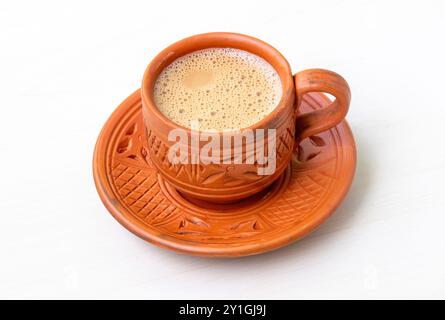 Hot milk tea or dudh cha served in a natural clay cup. Stock Photo