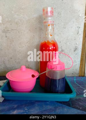 sauces, soy sauce, chili sauce in containers at food stalls Stock Photo