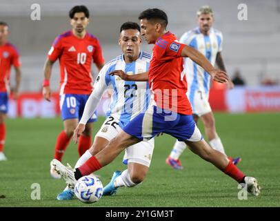 Buenos Aires, Argentina. 5th Sep, 2024. Lautaro Martinez (L) of Argentina vies with Marcelino Nunez of Chile during the 2026 FIFA World Cup South American qualification football match between Argentina and Chile in Buenos Aires, Argentina, Sept. 5, 2024. Credit: Martin Zabala/Xinhua/Alamy Live News Stock Photo