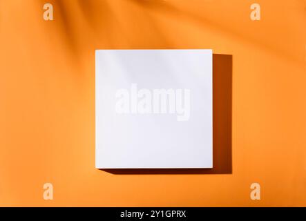 Empty square podium with tropical palm tree shadow background. Orange thanksgiving minimal flat lay frame poster. Abstract trendy geometric mockup bla Stock Photo