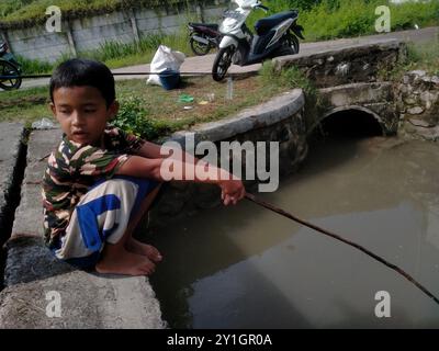 shot on boy fishing in a small river Stock Photo