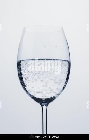 poured mineral water in wine glass, closeup Stock Photo