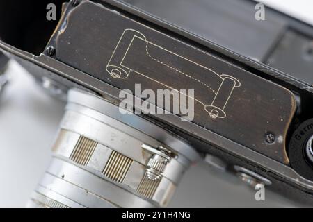 Close up of the open bottom and back compartment of a classic vintage camera for loading and unloading photo film rolls. Stock Photo