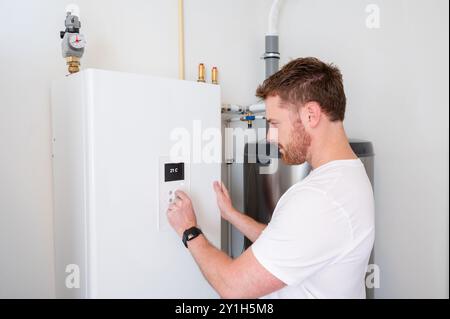 Technician checks the operation of a heat pump in a house. Stock Photo