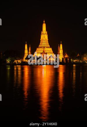 Beautiful Wat Arun Ratchawararam temple with reflexion in the river at twilight in Bangkok Thailand Stock Photo