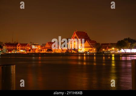 Beautiful Wat Arun Ratchawararam temple with reflexion in the river at twilight in Bangkok Thailand Stock Photo