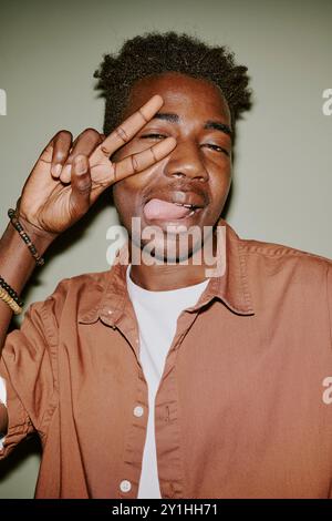 Young black man making faces while posing for photo Stock Photo