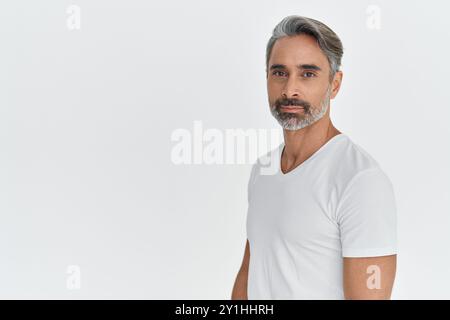 Confident middle aged man in 40s standing isolated on white studio background. Stock Photo