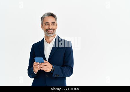 Smiling mature business man in suit using cellphone looking aside at copy space. Stock Photo