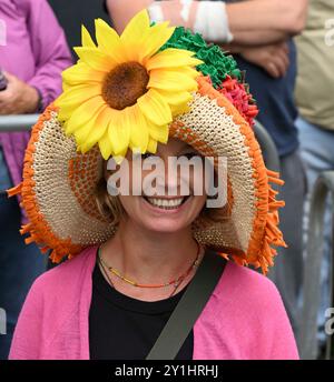 Bridport, Dorset, UK. 7th September 2024.  Hundreds of people wearing creatively decorated hats attend the annual Bridport Hat Festival at Bridport in Dorset.  Sunflower hat.  Picture Credit: Graham Hunt/Alamy Live News Stock Photo