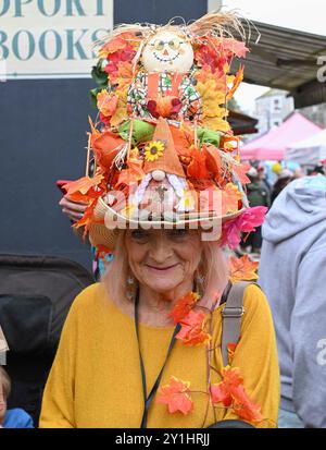 Bridport, Dorset, UK. 7th September 2024.  Hundreds of people wearing creatively decorated hats attend the annual Bridport Hat Festival at Bridport in Dorset.  Autumn leaf hat.  Picture Credit: Graham Hunt/Alamy Live News Stock Photo