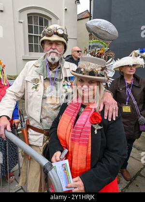 Bridport, Dorset, UK. 7th September 2024.  Hundreds of people wearing creatively decorated hats attend the annual Bridport Hat Festival at Bridport in Dorset.  Steam punk.  Picture Credit: Graham Hunt/Alamy Live News Stock Photo