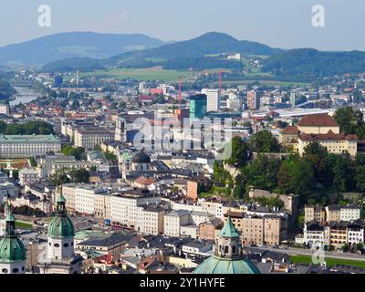 Salzburg, Austria - 31 Aug, 2024: This image showcases a panoramic view of a cityscape with rivers running through it, prominent churches, and various Stock Photo