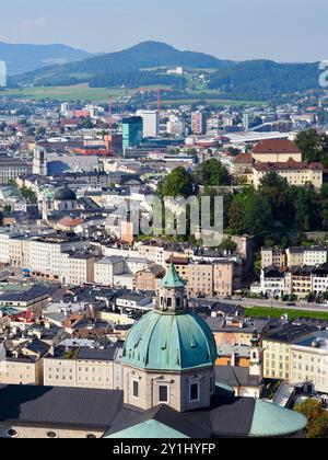 Salzburg, Austria - 31 Aug, 2024: This image showcases a panoramic view of a cityscape with rivers running through it, prominent churches, and various Stock Photo