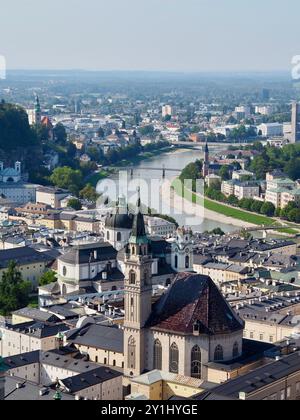 Salzburg, Austria - 31 Aug, 2024: This image showcases a panoramic view of a cityscape with rivers running through it, prominent churches, and various Stock Photo