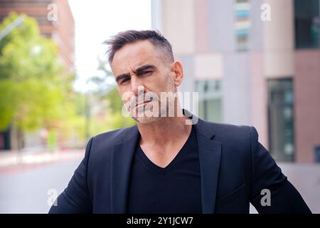 portrait of serious businessman looking at camera outdoors Stock Photo