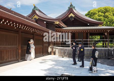 Tokyo, Japan - Jun 15, 2024: A traditional Japanese wedding processional takes place at the Meiji Jingu Shrine in the heart of the city during a summe Stock Photo