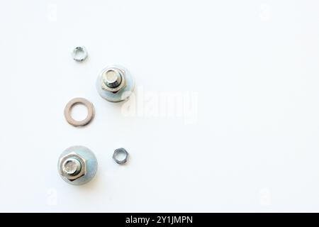 Set of bolts and hex nuts made of stainless steel for industrial or home repair. Mechanics gear isolated on white background Dismantled metallic parts Stock Photo