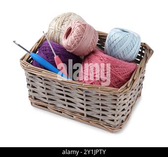 Many colorful yarns and crochet hooks in wicker basket isolated on white Stock Photo