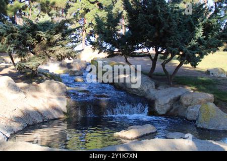 waterfall fountain with rock feature in park Stock Photo