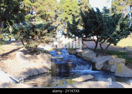 waterfall fountain with rock feature in park Stock Photo