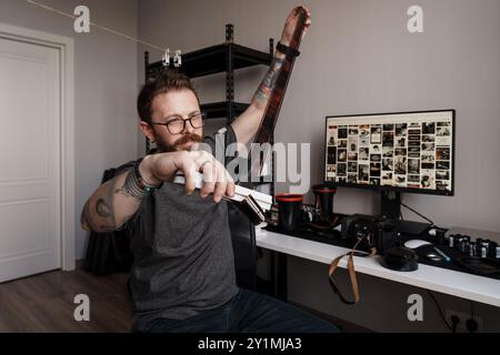 Photographer reviewing film negatives at a modern workstation Stock Photo