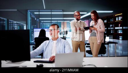 Business Team Using Tablet Technology. Standing Teamwork Stock Photo