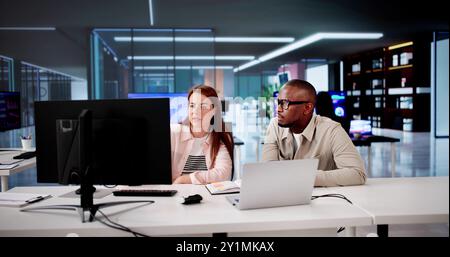 Business Meeting In Office. Corporate Employees Using Office Computer Stock Photo