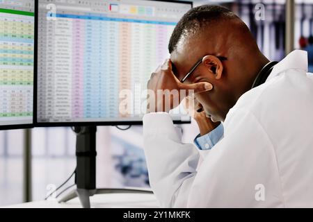 Sad Man Doctor Stress And Pain At Computer Stock Photo