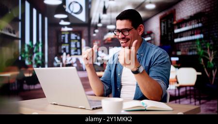 Excited Business Analyst Using Laptop Computer And Celebrating Win Stock Photo