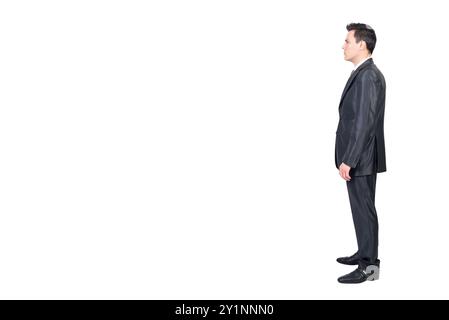 Serious male manager in suit standing in white studio Stock Photo
